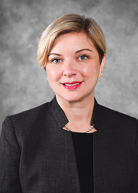 A straight-on portrait of Interim City Manager Kelley Gandurski. The background behind her is plain gray.