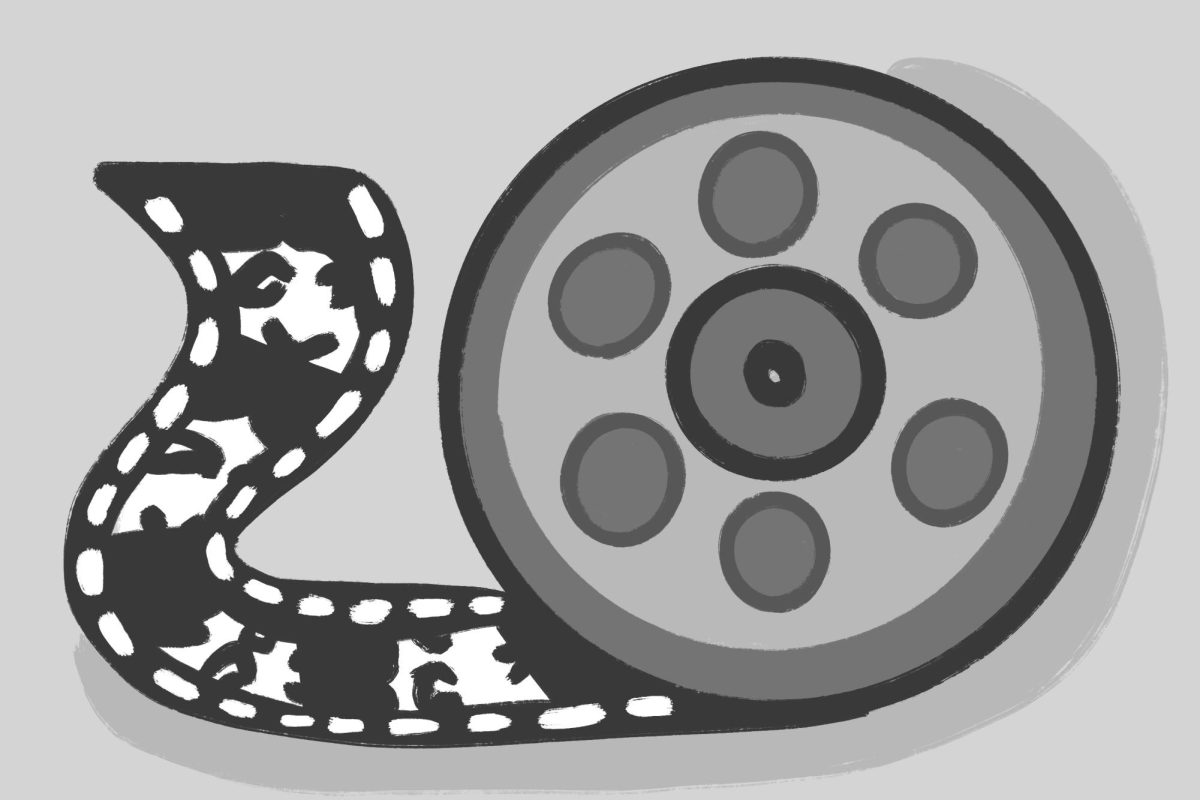 A gray film reel is half unrolled against a gray background.